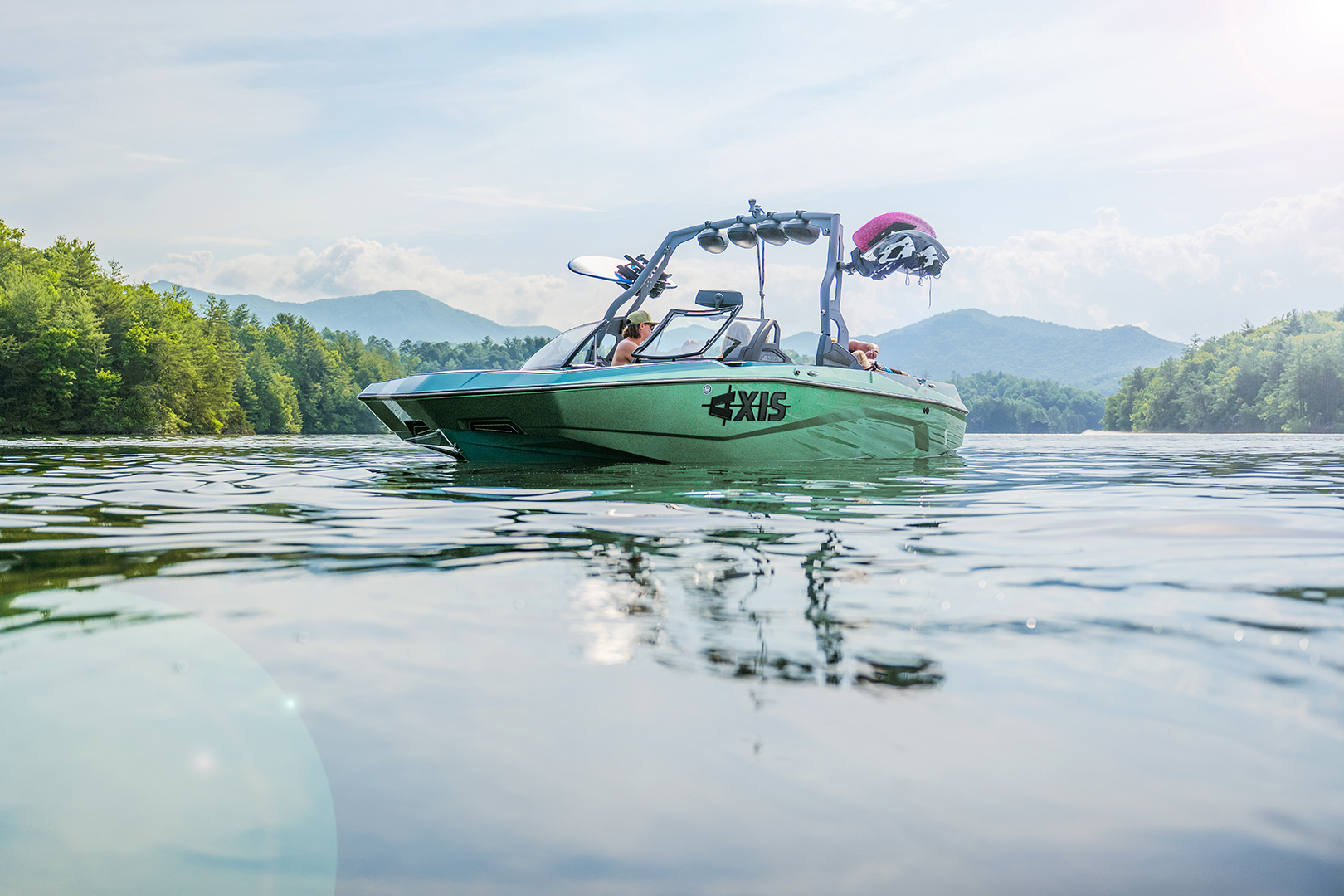 Front angle of the Axis A200 with tower and boards, reflecting in still lake water.
