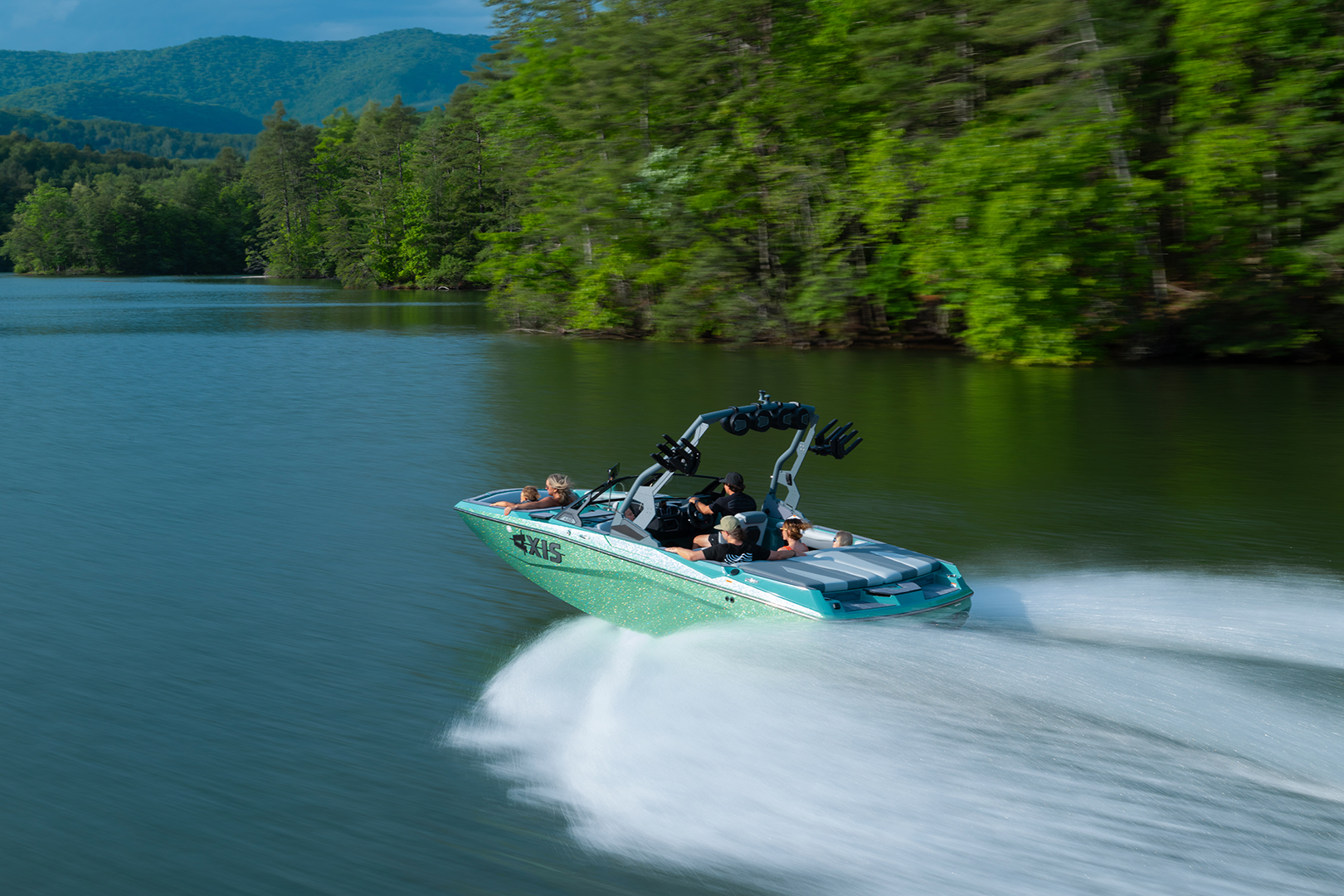 Axis A200 seen from behind, speeding across the lake surrounded by trees.