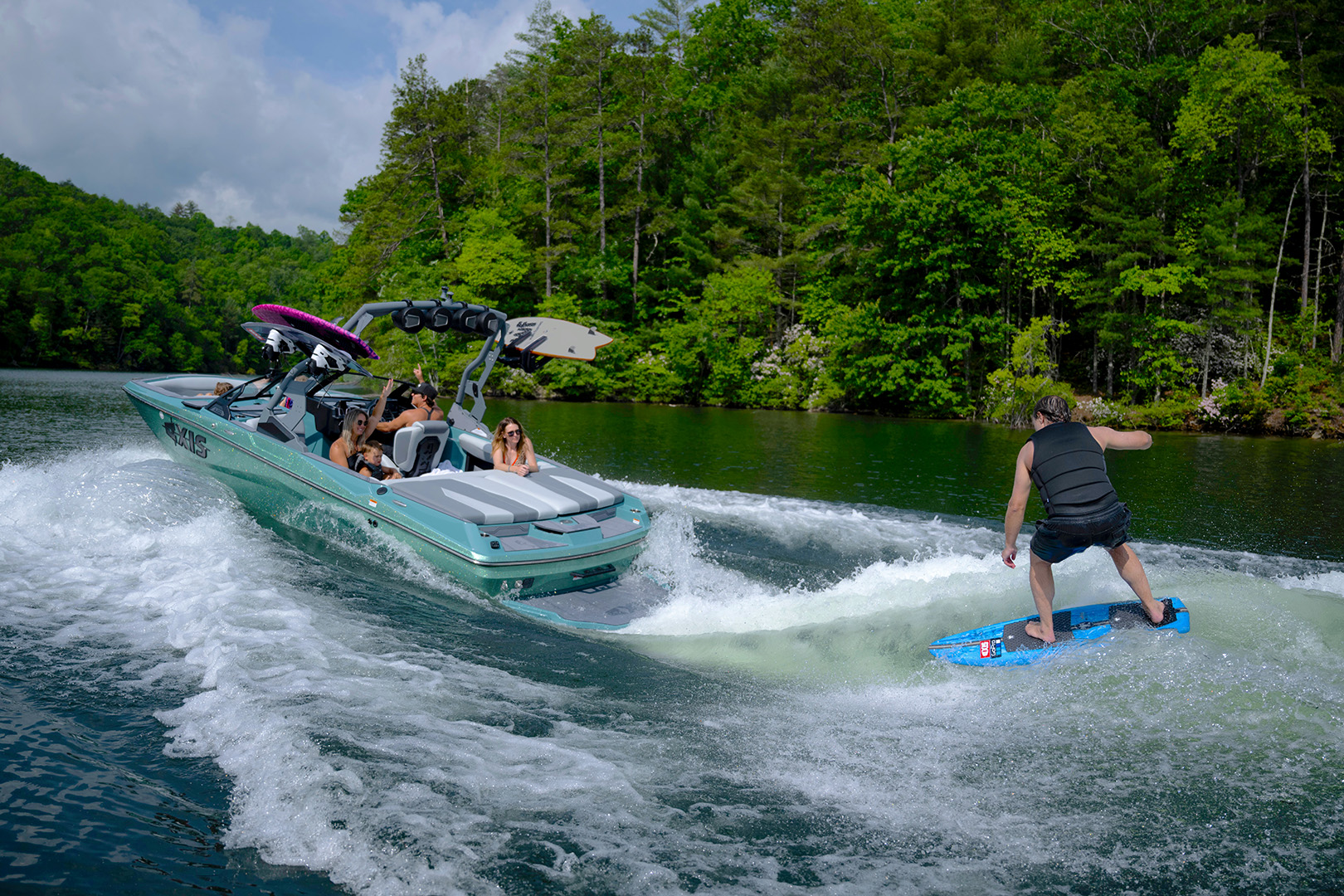 Rider initiates a surf trick behind the Axis boat, with full ballast and Power Wedge® III deployed for a steep, powerful wave.