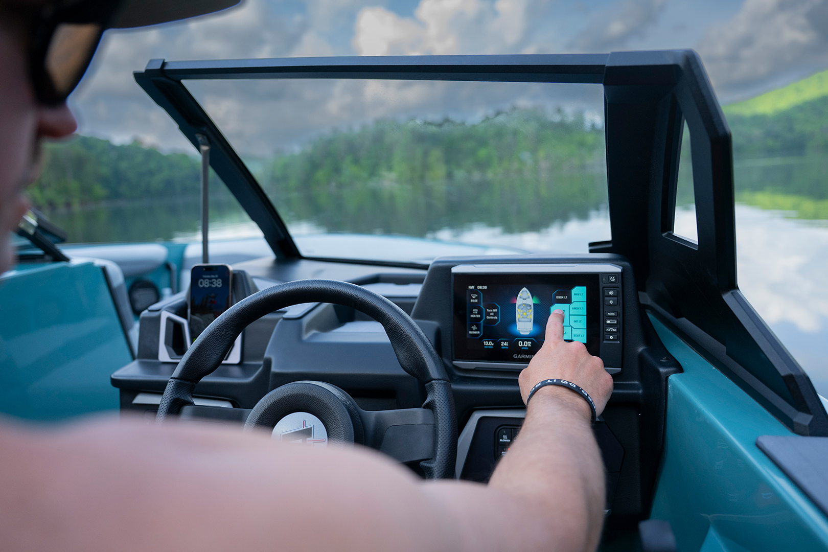 Driver operates touchscreen interface at the helm of the Axis A200 while cruising on the lake.